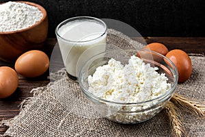 Ingredients for preparation cottage cheese pancakes. Cottage cheese, eggs, milk, sugar and flour