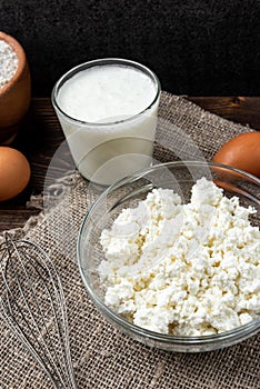 Ingredients for preparation cottage cheese pancakes. Cottage cheese, eggs, milk, sugar and flour