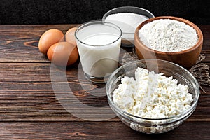 Ingredients for preparation cottage cheese pancakes. Cottage cheese, eggs, milk, sugar and flour