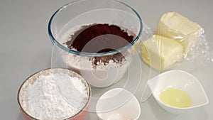 Ingredients prepared to make delicious cake on white table