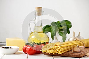 Ingredients for recipe of italian pasta dish on white background.