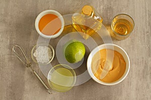 Ingredients for salad dressing with lemon juice, honey and mustard