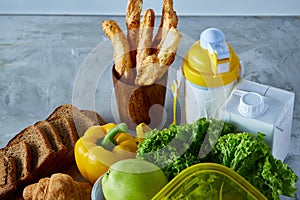 Ingredients for school lunch and plastic container on the table, close-up, selective focus