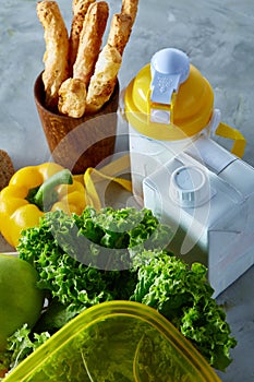 Ingredients for school lunch and plastic container on the table, close-up, selective focus