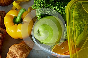 Ingredients for school lunch and plastic container on the table, close-up, selective focus