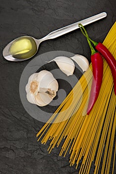 Ingredients for Spaghetti aglio e olio on black slate stone background