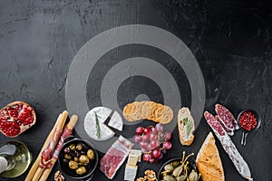 Ingredients for spanish food, meat cheede, herbs, on black background, top view  with copy space for text