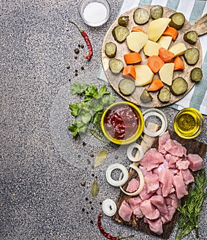 Ingredients for the stew with turkey and vegetables border ,place for text wooden rustic background top view close up