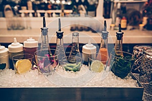 Ingredients and syrups for cocktails at bar counter in the the nightclub. photo
