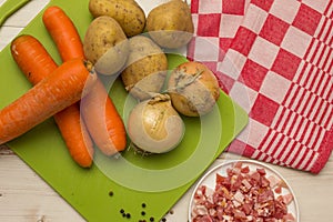 Ingredients to make typical dutch hutspot, with carrot, onion, a