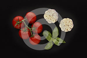 Ingredients for tomato sause, including garlic and basil.