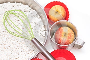 Ingredients and tools to make a cake, flour, apple and sugar