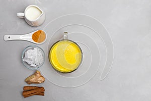 Ingredients for turmeric golden milk on grey neutral background