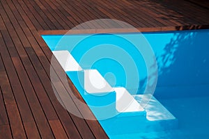 Inground pool steps access into pool, swimming pool deck edge