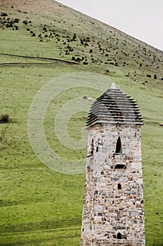 Ingush watchtower on a background of the Caucasus mountains