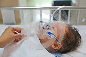 Inhalation baby boy age about 1 years old on patient bed. Respiratory Syncytial Virus RSV. Intensive care on bed at hospital