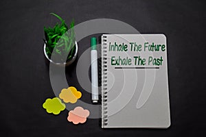 Inhale The Future. Exhale The Past write on a book  on office desk. Christian faith concept