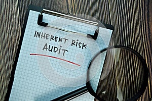 Inherent Risk Audit write on a paperwork isolated on Wooden Table. Business or Financial Concept photo