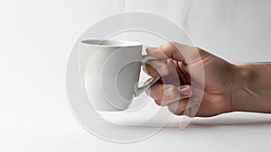 Inimalistic emphasizing the clean design of the mug and the hand s