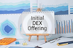 Initial DEX Offering calculator and red notepad. text about business