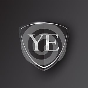 Initial logo letter YE with shield Icon silver color isolated on black background, logotype design for company identity