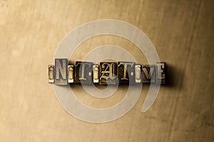 INITIATIVE - close-up of grungy vintage typeset word on metal backdrop