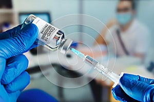 Injecting dose of vaccine in syringe for vaccination of Coronavirus from a patient