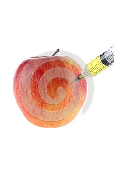 Injection into an apple. A hand in a medical glove with a syringe on a White background. Genetic modified foods. Injection of GMOs