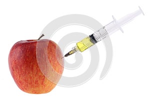 Injection into an apple. A hand in a medical glove with a syringe on a White background. Genetic modified foods. Injection of GMOs