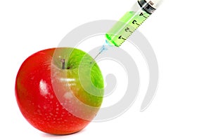 Injection green into red fresh wet apple with syringe on white background for renew energy , therapy or refresh or boost up energy