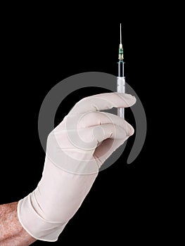 Injection - hand with syringe needle over black