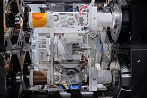 Production of empty plastic cups - injection molding machine during work