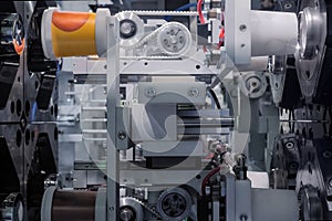 Injection molding machine during work: production of empty plastic cups