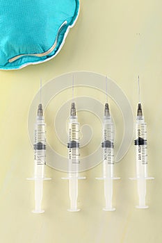 Injection over a table with medicaments and coronavirus blood test. Vaccine concept.