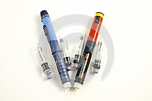 Injection pens and cartridge on a white background. photo