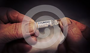 Injection of Steroid Ampoule in a Wrinkled Hands.