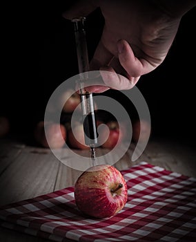 Injection of toxin into an organic apple