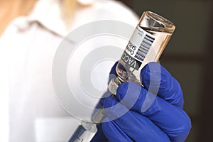 Injection vaccine, covid-19 coronavirus vaccination, doctor uses vaccine vial with syringe needle close-up