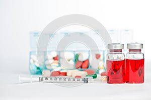 Injection vials and medicine in weekly pill box