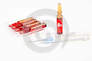 Injection of vitamins B 12. Ampoules with red liquid. Copy space photo