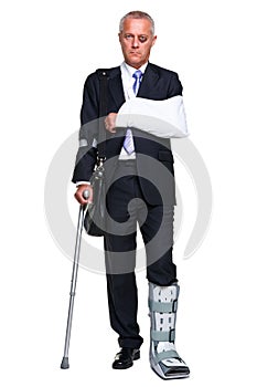 Injred businessman on crutches on white