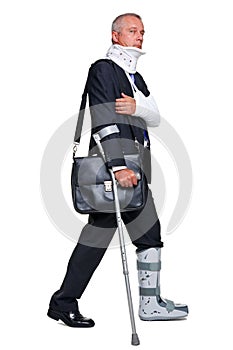 Injred businessman on crutches on white