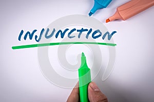 Injunction. Text and colored markers on a white background photo