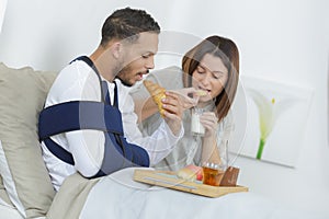 injured boy having breakfast in bed