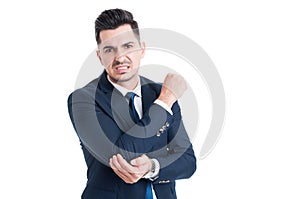 Injured businessman suffering of elbow pain