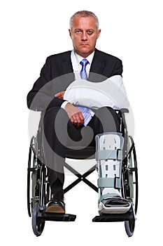 Injured businessman in a wheelchair isolated