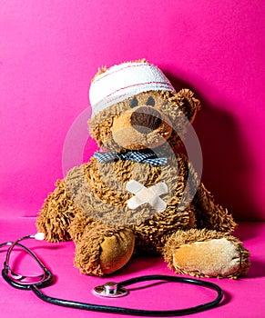 Injured child`s teddy bear with a belly and head