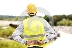 Injured construction worker or engineer suffering backpain