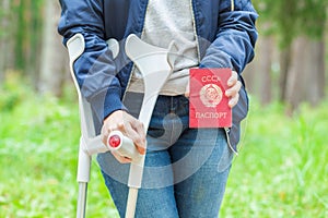 Injured Female With Crutches holding soviet union passport