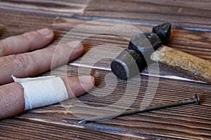 The injured hand of the joiner. Nail and hammer. Hammer on the finger